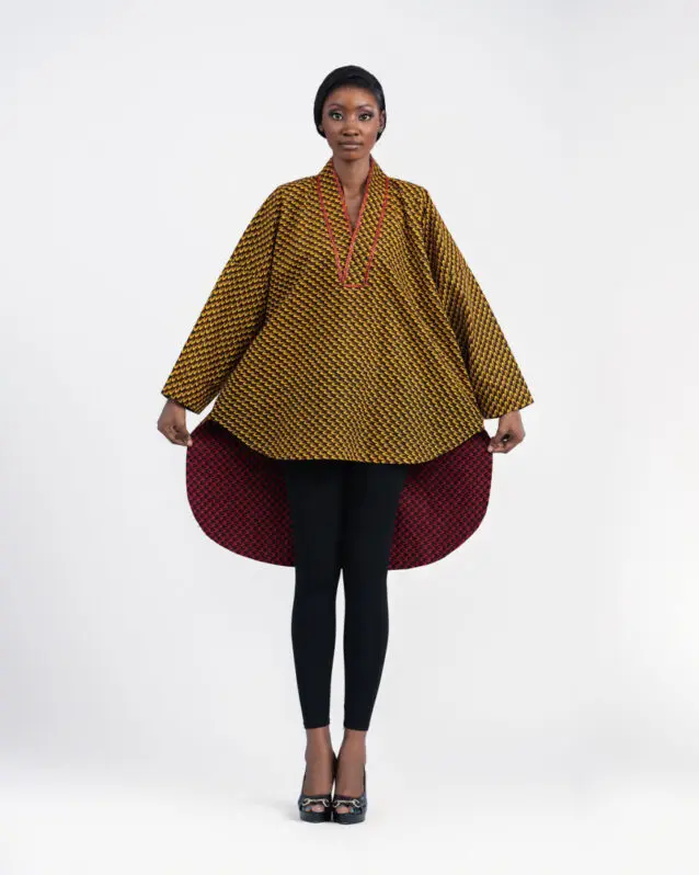 Model in a mustard printed top with a wide flared hem